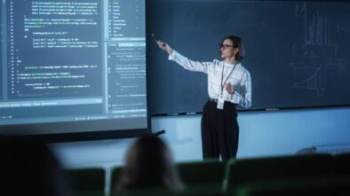 A Lady Trainer Explains The Data Science Concept In A Big Screen