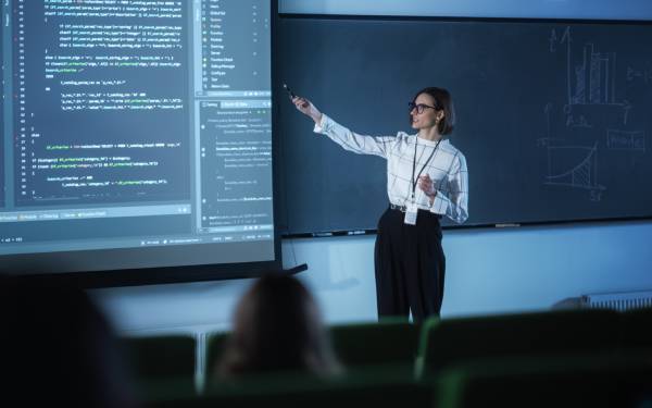 A Lady Trainer Explains The Data Science Concept In A Big Screen